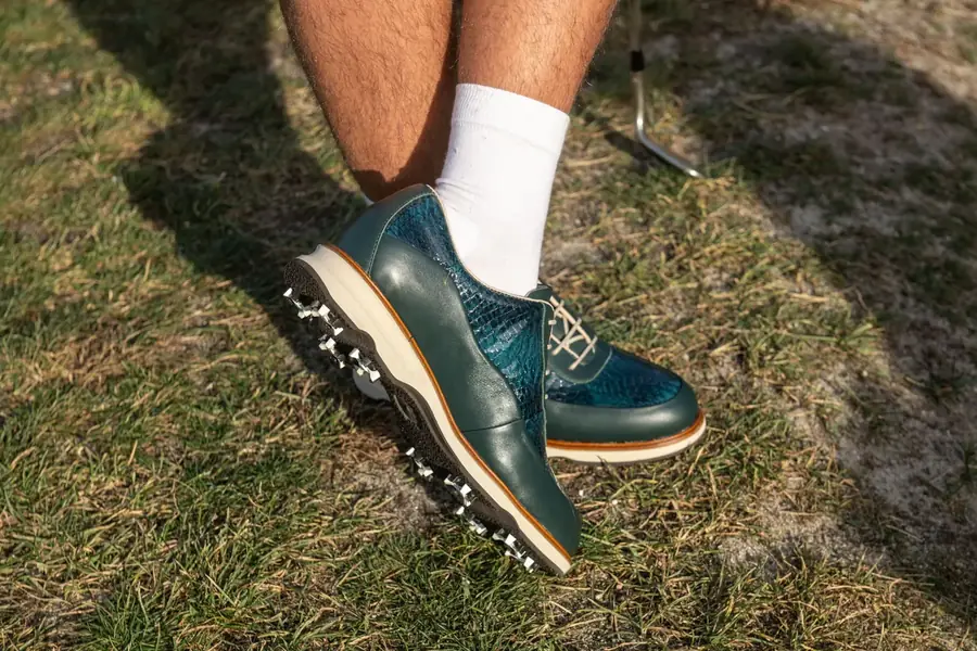Teal croco Lambda classic golf shoe with spikes on the fairway